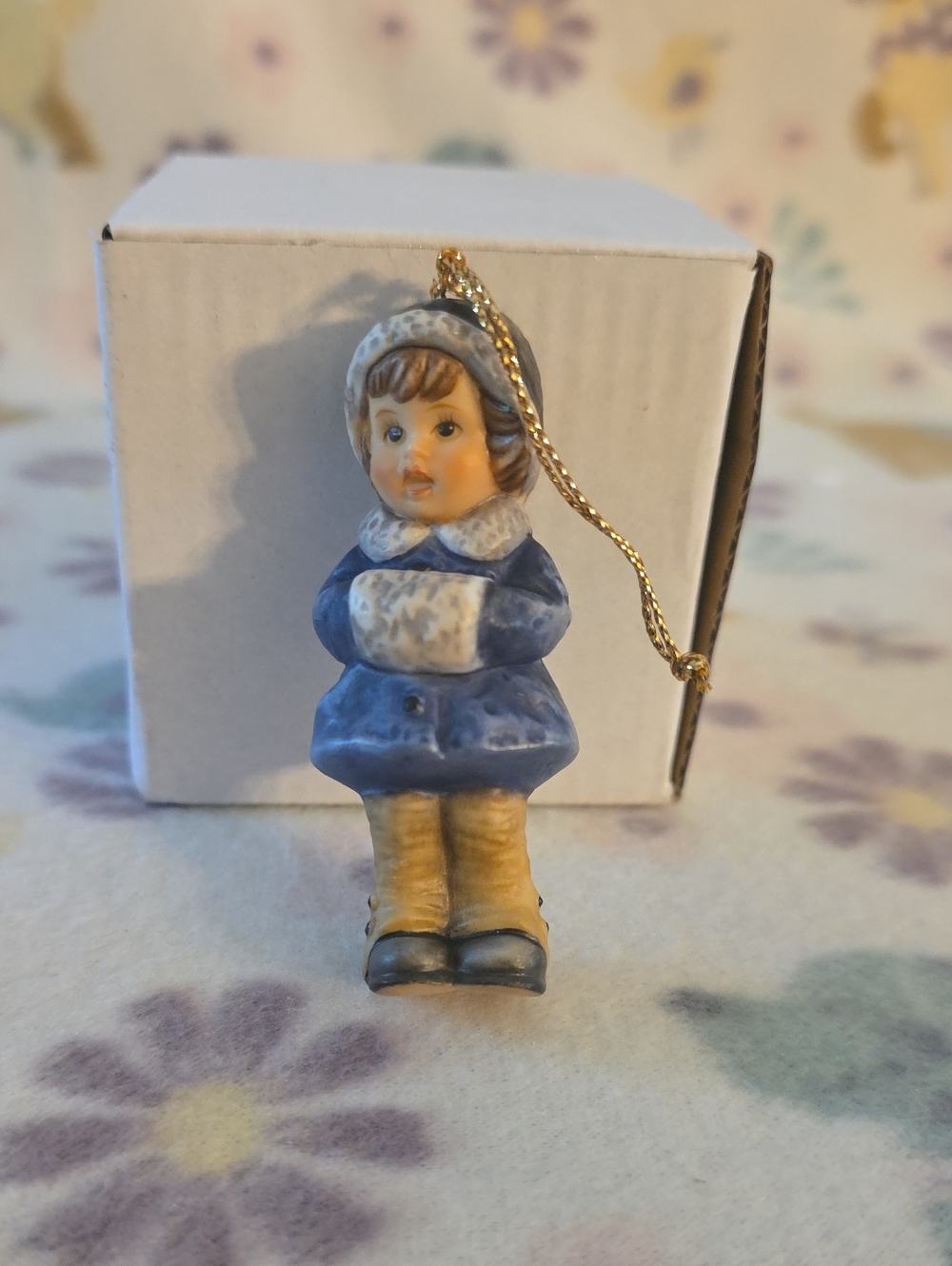 This is a 1999 Berta Hummel Goebel ornament named "Snug and Warm,"